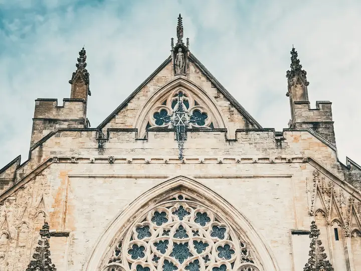 The carved stone front and tracery window of Exeter Cathedral